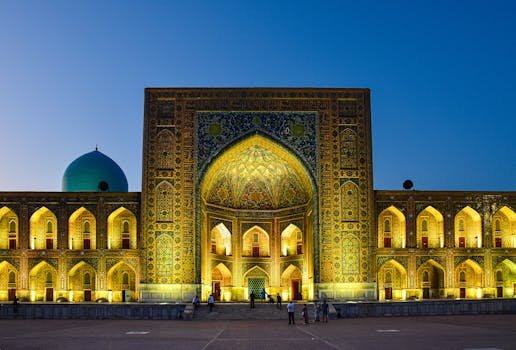 A stunning view of the Tilya-Kori Madrasah in Uzbekistan illuminated against a twilight sky, showcasing intricate architecture.